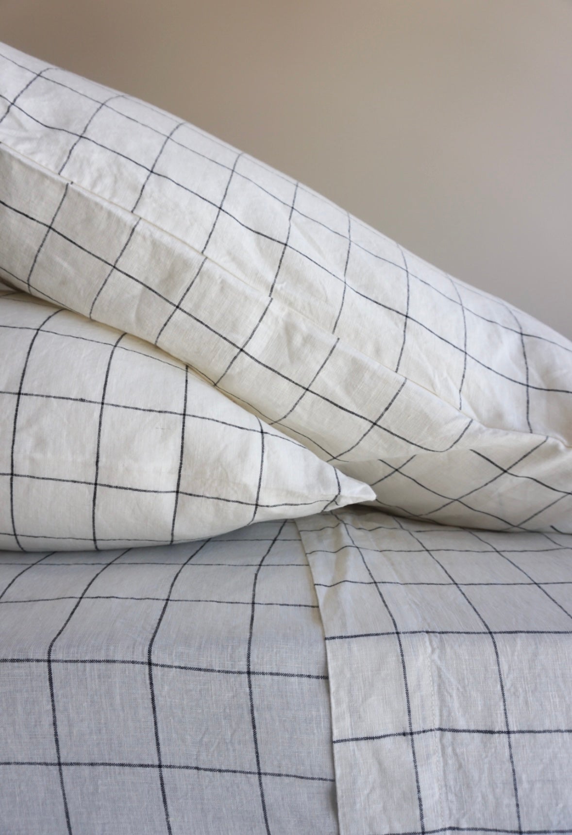 Simple Linen Co. 100% French flax linen sheet set in Black Grid, stonewashed for added softness and durability, sheet set includes pillowcase/s, flat sheet and fitted sheet, sustainably packaged in reusable linen drawstring bag.