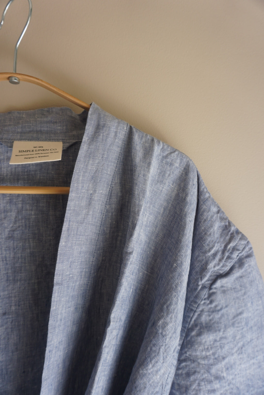Simple Linen Co. Close up detail view of hanging 100% French Flax dressing gown in Light Denim.