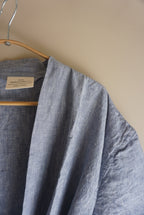Simple Linen Co. Close up detail view of hanging 100% French Flax dressing gown in Light Denim.