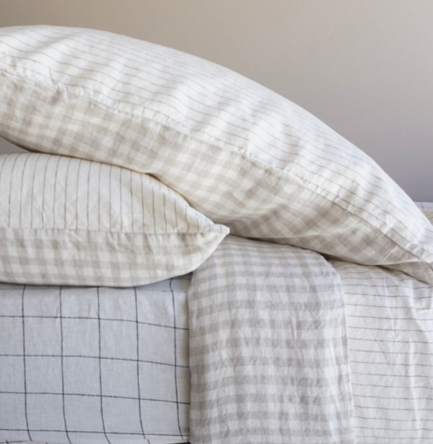 Simple Linen Co. 100% French flax linen double sided duvet cover set Elowyn in Olive pinstripe and Dove Grey Gingham, paired with Black grid sheet, sustainably packaged in reusable linen drawstring bag, stonewashed for softness and breathable year-round comfort.