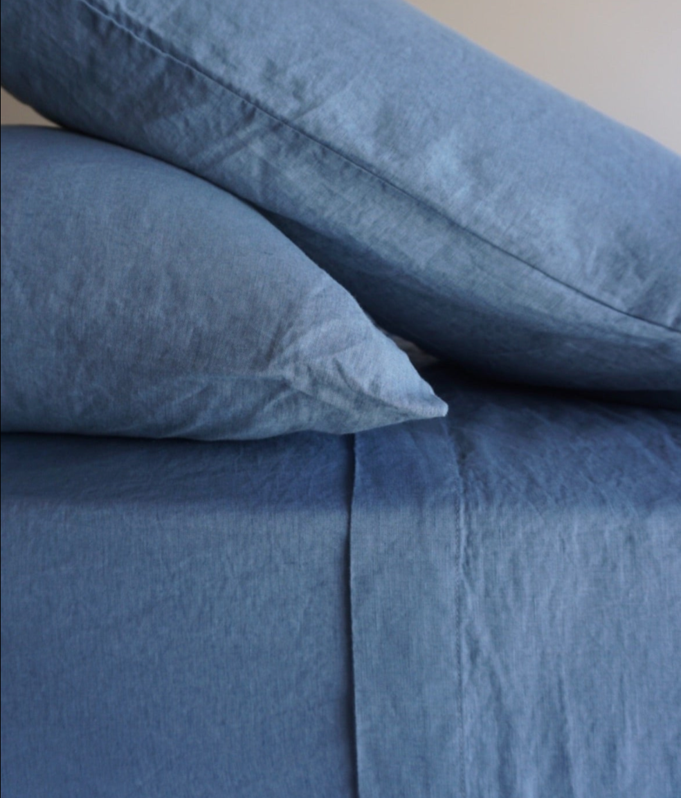 Simple Linen Co. 100% French flax linen sheet set in Lake Blue, stonewashed for added softness and durability, sheet set includes pillowcases, flat sheet and fitted sheet, sustainably packaged in reusable linen drawstring bag.