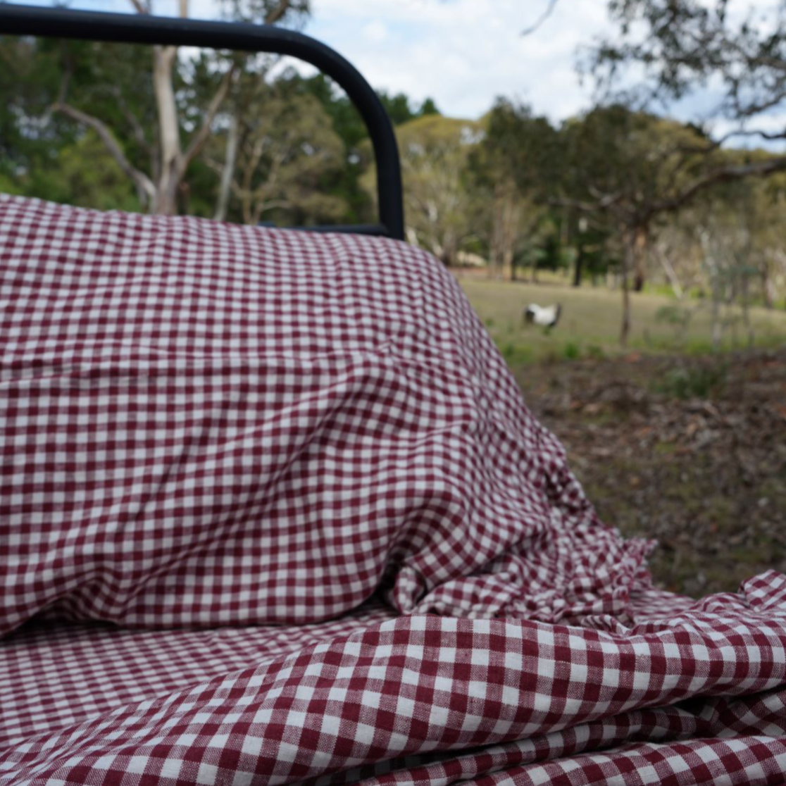 Simple Linen Co. 100% French flax linen ruffle edged sheet set in Mulberry Red Gingham, stonewashed for added softness and durability, sheet set includes pillowcases, flat sheet and fitted sheet. Pillowcases and Top sheet are ruffled edge.