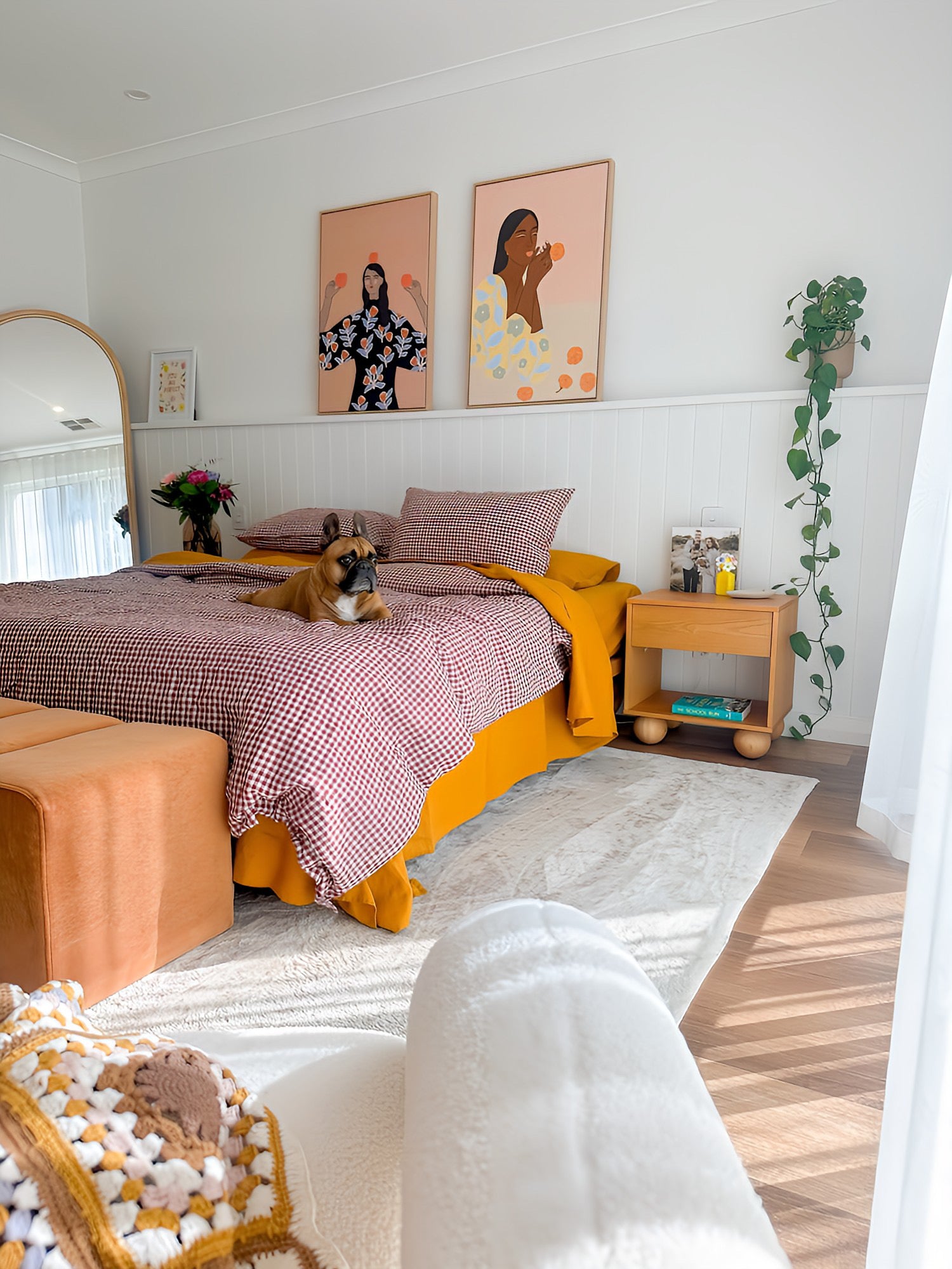 Simple Linen Co. 100% French flax linen  duvet cover Margot in Red Mulberry Gingham, paired with Mustard sheet set in a colourful bedroom with a dog on the bed. Stonewashed for softness and breathable year-round comfort.