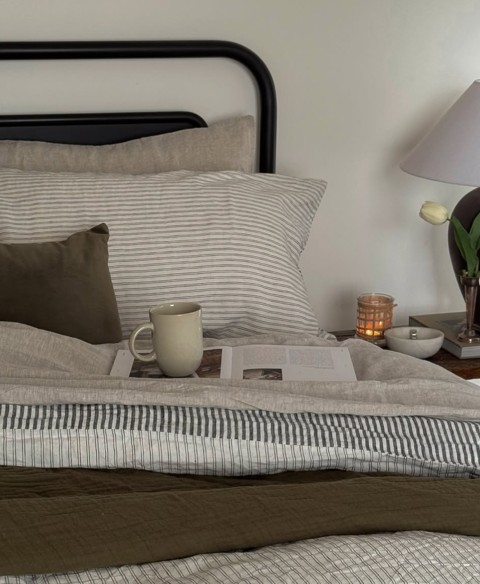 Simple Linen Co. 100% French flax linen sheet set in Nature, featuring Ida Duvet Cover with a double pinstripe and charcoal stripe, in cozy wintery bedroom setting.