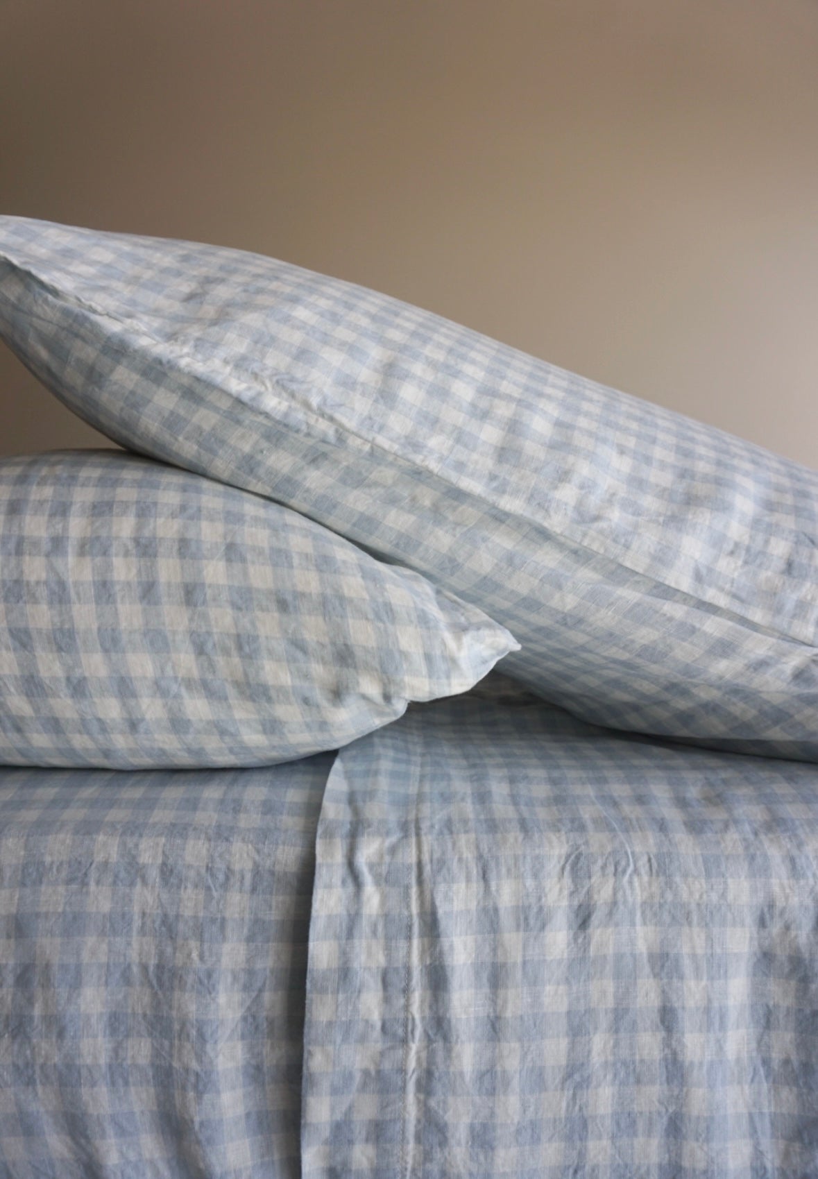 Simple Linen Co. 100% French flax linen sheet set in pale blue gingham, stonewashed for added softness and durability, sheet set includes pillowcase/s, flat sheet and fitted sheet, sustainably packaged in reusable linen drawstring bag.