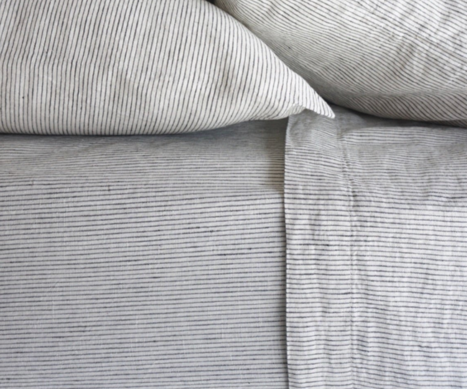 Simple Linen Co. 100% French flax linen sheet set in Pinstripe, stonewashed for added softness and durability, sheet set includes pillowcases, flat sheet and fitted sheet, sustainably packaged in reusable linen drawstring bag.